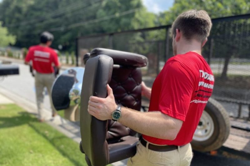 Junk Removal Pro Carrying Chair To Truck