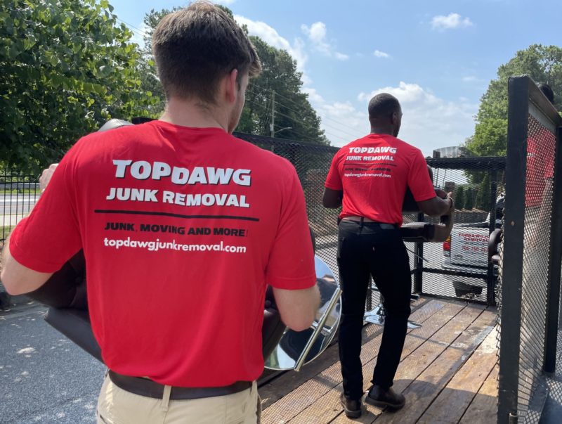junk removal pros carrying items to a truck