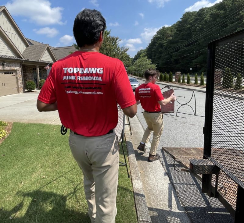 TopDawg Junk Removal Pros Carrying Chairs To Truck